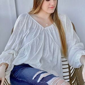 Textured knit solid babydoll top with V back.